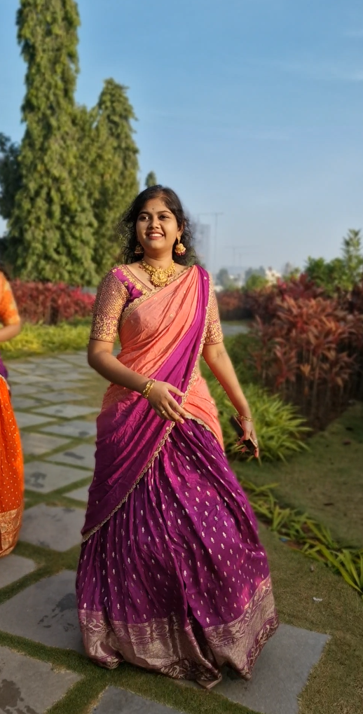A bright Purple lehenga with golden motifs and a radiant golden border, paired with a matching running blouse 